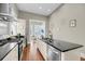 Spacious kitchen with island and stainless appliances with an open doorway at 68 Vanderhorst St # A, Charleston, SC 29403