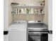 Convenient laundry room includes washer, dryer, and shelving for storage at 68 Vanderhorst St # A, Charleston, SC 29403