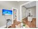 Open-concept living room with hardwood floors and a tv room beyond a doorway at 68 Vanderhorst St # A, Charleston, SC 29403