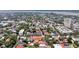 City aerial view highlighting colorful rooftops, tree-lined streets, and a distant waterfront at 68 Vanderhorst St # B, Charleston, SC 29403