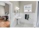 Bright bathroom features black and white tile floors, pedestal sink, and traditional design at 68 Vanderhorst St # B, Charleston, SC 29403
