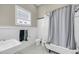 Bright bathroom featuring a claw foot tub and charming fixtures at 68 Vanderhorst St # B, Charleston, SC 29403