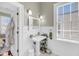 Bright bathroom featuring a pedestal sink, hexagon tile floor, and decorative wainscoting at 68 Vanderhorst St # B, Charleston, SC 29403