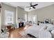 Bright bedroom featuring a fireplace, ceiling fan, and lots of space at 68 Vanderhorst St # B, Charleston, SC 29403