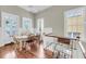 Spacious dining area with wood floors, table, and chairs; filled with natural light from large windows at 68 Vanderhorst St # B, Charleston, SC 29403