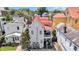 Quaint multi-story home with a charming balcony and vibrant red roof among lush greenery and neighboring houses at 68 Vanderhorst St # B, Charleston, SC 29403