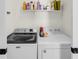 A laundry room with white walls and a shelf filled with detergents at 68 Vanderhorst St # B, Charleston, SC 29403