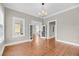 Bright living room with hardwood floors, chandelier, and glass panel doors at 68 Vanderhorst St # B, Charleston, SC 29403