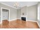 Living room with fireplace, hardwood floors and natural light from windows at 68 Vanderhorst St # B, Charleston, SC 29403