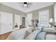 Bedroom with ceiling fan, wood floors, ensuite bath, and decor at 68 Vanderhorst St # B, Charleston, SC 29403