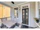 View from porch with table and chairs showcasing black exterior doors and window at 68 Vanderhorst St # B, Charleston, SC 29403