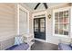 Charming porch with seating, decorative pillow, and dark wood flooring at 68 Vanderhorst St # B, Charleston, SC 29403
