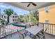 View from porch with ceiling fan, table with chairs, and colorful hammock at 68 Vanderhorst St # B, Charleston, SC 29403