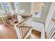 View of the wooden staircase and dining room with lots of natural light at 68 Vanderhorst St # B, Charleston, SC 29403