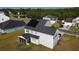 Aerial view of a two-story house with solar panels and screened in porch in a residential neighborhood at 6976 Pumpkinseed Dr, Johns Island, SC 29455