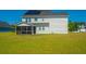 Backyard view features a screened in porch and solar panels on a two-story house at 6976 Pumpkinseed Dr, Johns Island, SC 29455