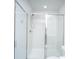 Bright, all-white bathroom with shower featuring glass doors and chrome hardware at 6976 Pumpkinseed Dr, Johns Island, SC 29455