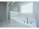 Beautiful primary bathroom features a shower and a soaking tub with natural light at 6976 Pumpkinseed Dr, Johns Island, SC 29455