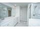 Bright, spacious bathroom with a double vanity, white cabinets and a walk-in shower at 6976 Pumpkinseed Dr, Johns Island, SC 29455