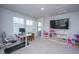 Spacious bedroom with a desk, treadmill, and a TV, perfect for work and play at 6976 Pumpkinseed Dr, Johns Island, SC 29455