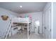 Comfortable bedroom with a bed, desk, chair, full-length mirror, and door, ideal for study and relaxation at 6976 Pumpkinseed Dr, Johns Island, SC 29455