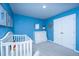 Bright blue Bedroom with crib, dresser, and closet offers a cozy and organized space at 6976 Pumpkinseed Dr, Johns Island, SC 29455