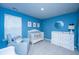 Bright blue Bedroom featuring a cozy chair, crib, dresser, and window with natural light at 6976 Pumpkinseed Dr, Johns Island, SC 29455