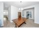 Bright dining area features wood floors, stylish chandelier, and access to additional living spaces at 6976 Pumpkinseed Dr, Johns Island, SC 29455