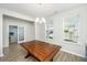 Dining room with wood table and view into the office through glass panel doors at 6976 Pumpkinseed Dr, Johns Island, SC 29455