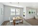 Cozy dining area with wood table, white chairs, and modern light fixture at 6976 Pumpkinseed Dr, Johns Island, SC 29455