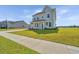 Two-story home with a manicured lawn, covered porch, and traditional architectural details at 6976 Pumpkinseed Dr, Johns Island, SC 29455