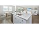 Modern kitchen with a stainless steel dishwasher and a view into the living room with a dining area at 6976 Pumpkinseed Dr, Johns Island, SC 29455