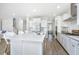 Bright, modern kitchen with white cabinets, a spacious island, and stainless steel appliances at 6976 Pumpkinseed Dr, Johns Island, SC 29455
