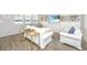 Bright living room with built-in shelving, modern decor, and wood flooring at 6976 Pumpkinseed Dr, Johns Island, SC 29455