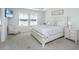 Bright primary bedroom with a bed, a nightstand, and large windows looking out to the water at 6976 Pumpkinseed Dr, Johns Island, SC 29455