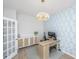 Bright home office featuring a wooden desk, stylish light fixture, and modern cabinet at 6976 Pumpkinseed Dr, Johns Island, SC 29455