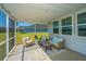 Comfortable screened-in patio with stylish seating and a peaceful view of the backyard at 6976 Pumpkinseed Dr, Johns Island, SC 29455