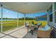 Relaxing screened patio features comfortable seating and beautiful view of the lake at 6976 Pumpkinseed Dr, Johns Island, SC 29455