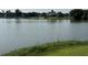 A pond with grassy banks and a covered pavilion in the background, providing a scenic view at 6976 Pumpkinseed Dr, Johns Island, SC 29455