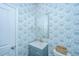 Stylish powder room with designer wallpaper, vanity with sink and modern fixtures at 6976 Pumpkinseed Dr, Johns Island, SC 29455