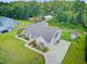 Well-maintained home with lush landscaping, a driveway leading to a detached garage, and a large private yard at 708 Tierra Loop, Summerville, SC 29483