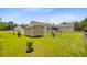 View of the large backyard with grass, landscaping, storage shed, and the home's rear exterior at 708 Tierra Loop, Summerville, SC 29483