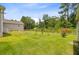 Wide, grassy backyard with a low wood fence and view of the surrounding woods at 708 Tierra Loop, Summerville, SC 29483