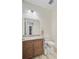 A bathroom with granite countertop, a mirror, a toilet, and unique flooring, presenting a clean and functional space at 708 Tierra Loop, Summerville, SC 29483
