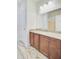 Bathroom vanity with granite counters, stained cabinets and large mirror at 708 Tierra Loop, Summerville, SC 29483