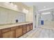 Bathroom featuring double sinks, granite countertops, framed mirrors, wood cabinets and a glass enclosed shower at 708 Tierra Loop, Summerville, SC 29483