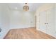 Bright bedroom features a decorative light fixture, wood floors, and closet at 708 Tierra Loop, Summerville, SC 29483