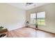 A well-lit, empty bedroom with hardwood floors, two windows, and a ceiling fan, perfect for customization at 708 Tierra Loop, Summerville, SC 29483