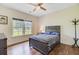This cozy bedroom features wood floors, a ceiling fan, and a view of the front yard at 708 Tierra Loop, Summerville, SC 29483