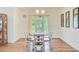 Dining room with wood floors, seating for four, and a sliding door with access to a balcony at 708 Tierra Loop, Summerville, SC 29483